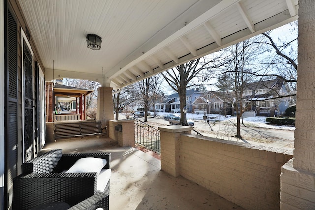 snow covered patio with covered porch