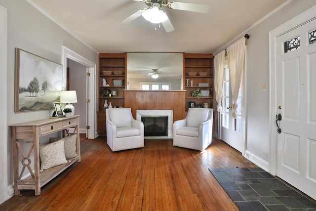 interior space with crown molding, ceiling fan, and dark hardwood / wood-style flooring