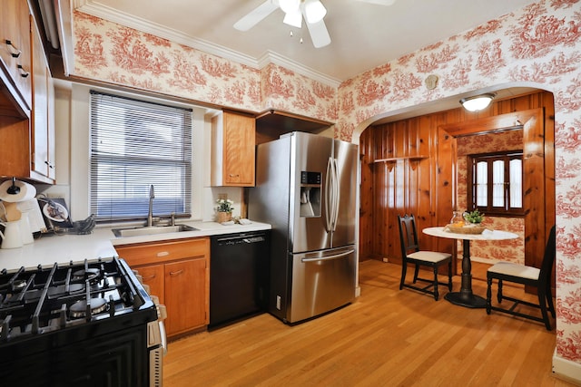 kitchen featuring sink, crown molding, appliances with stainless steel finishes, ceiling fan, and light hardwood / wood-style floors