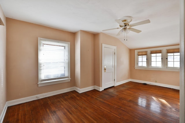 spare room featuring vaulted ceiling, dark wood-type flooring, and ceiling fan