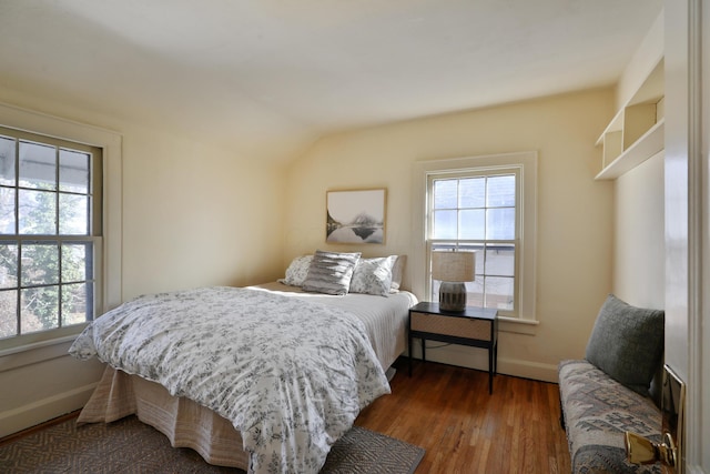 bedroom with lofted ceiling and dark hardwood / wood-style flooring