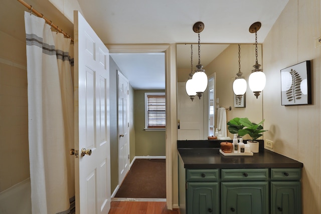 bathroom featuring vanity, hardwood / wood-style floors, and walk in shower