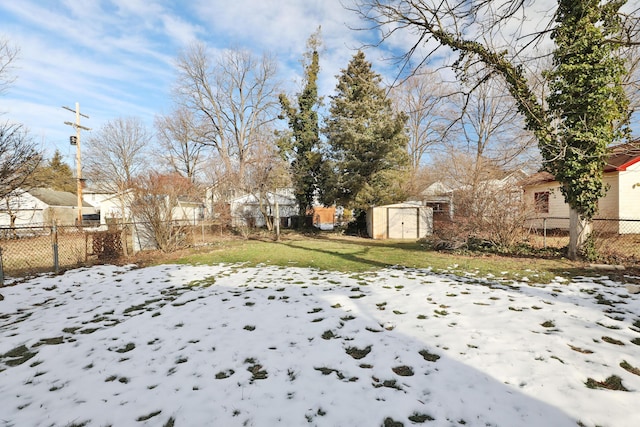 snowy yard with a storage unit