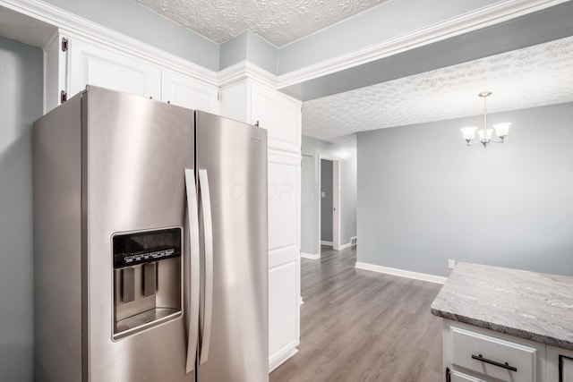 kitchen with white cabinetry, light wood-type flooring, a textured ceiling, and stainless steel fridge with ice dispenser