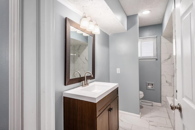 bathroom featuring vanity, a textured ceiling, and toilet