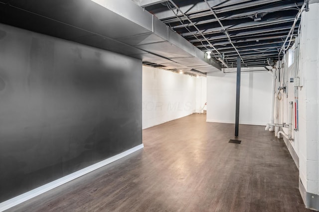 basement featuring dark hardwood / wood-style floors