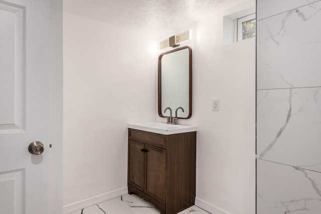 bathroom featuring vanity and a textured ceiling