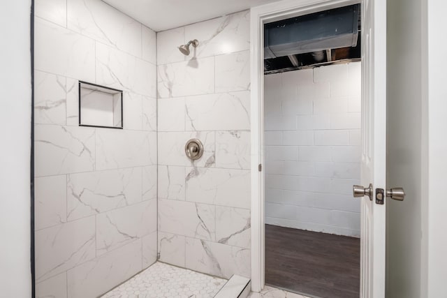 bathroom with a tile shower