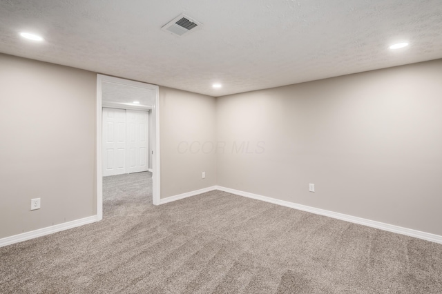 basement with carpet and a textured ceiling