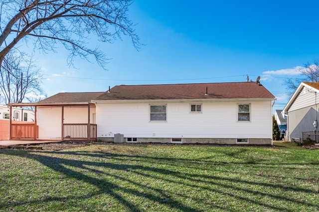 rear view of property featuring central AC unit and a lawn