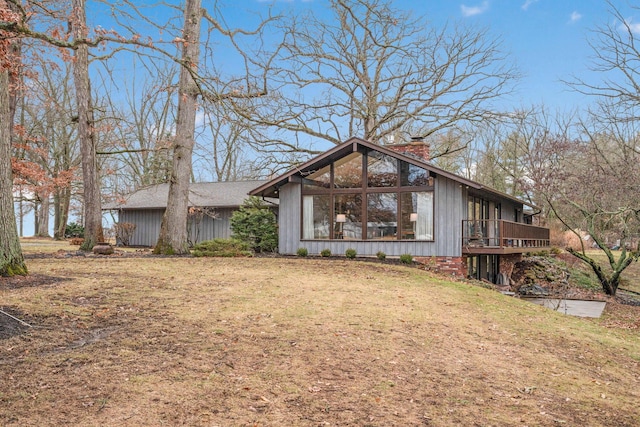 view of front facade with a front yard and a deck