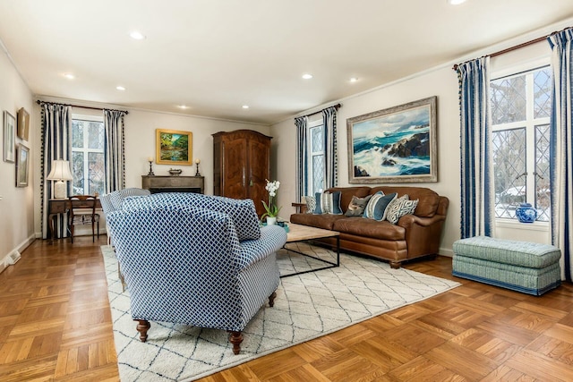 living room with ornamental molding and light parquet floors