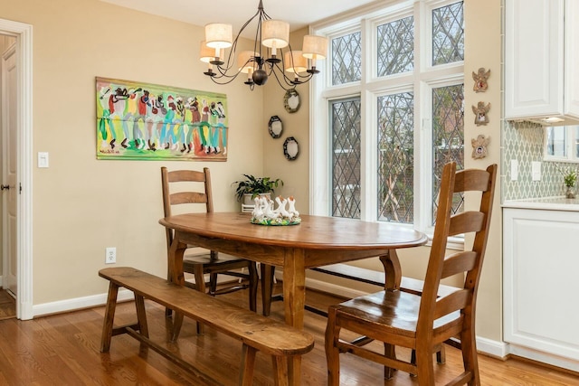 dining room with a notable chandelier and light hardwood / wood-style flooring