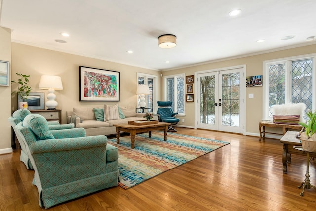 living room with french doors, crown molding, and wood-type flooring