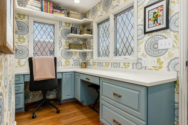 home office with light hardwood / wood-style floors