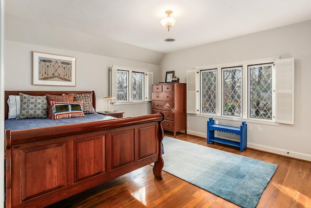 bedroom featuring vaulted ceiling and hardwood / wood-style floors