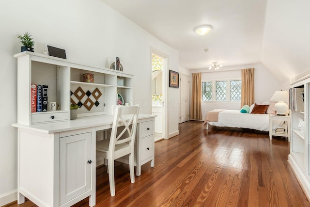 bedroom featuring dark hardwood / wood-style flooring and lofted ceiling