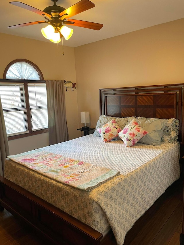 bedroom with ceiling fan and wood-type flooring