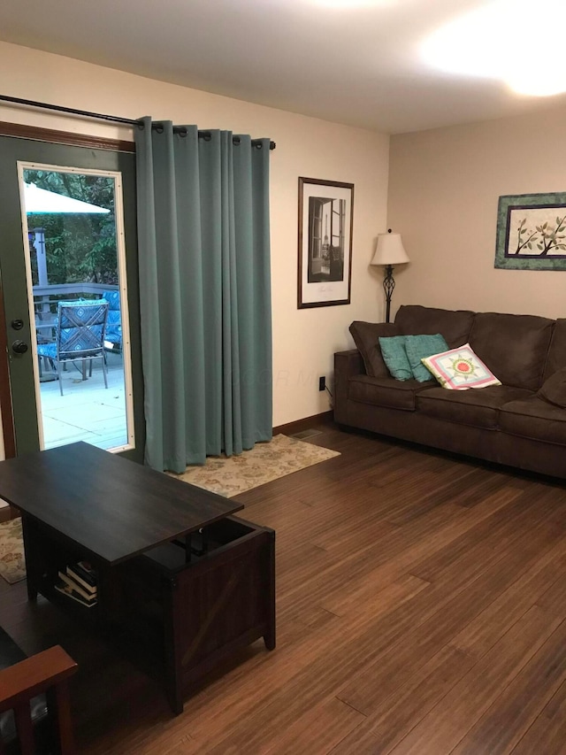 living room with dark hardwood / wood-style flooring