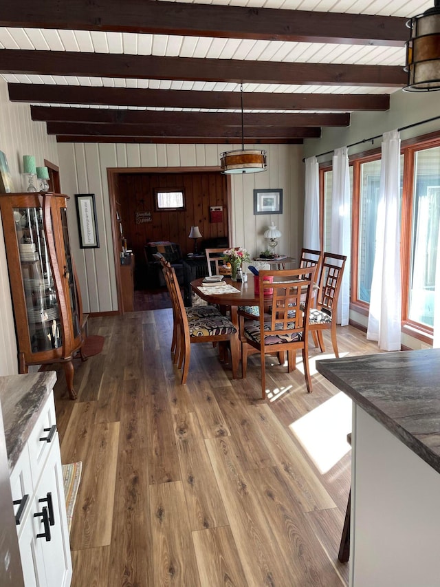 dining room with wood ceiling, wood-type flooring, and beamed ceiling