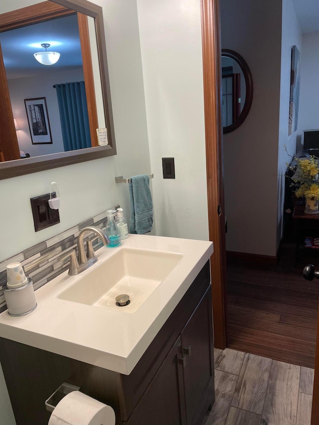 bathroom with hardwood / wood-style flooring and vanity