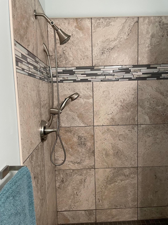 interior details with a tile shower