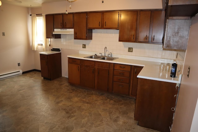 kitchen featuring a baseboard heating unit, sink, and decorative backsplash