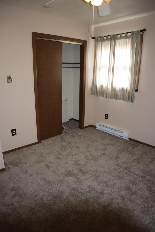 unfurnished bedroom with ceiling fan, a baseboard radiator, a closet, and carpet