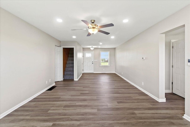 interior space with a ceiling fan, baseboards, recessed lighting, visible vents, and stairway