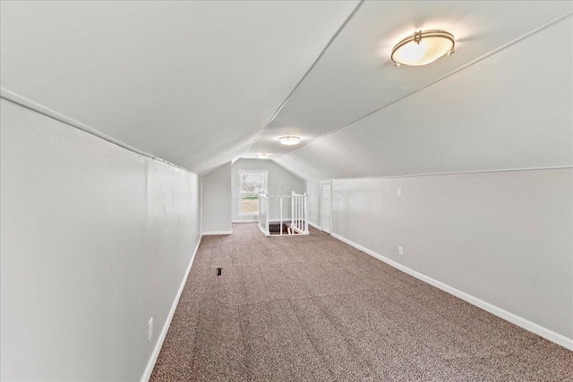 bonus room with baseboards, vaulted ceiling, and carpet flooring