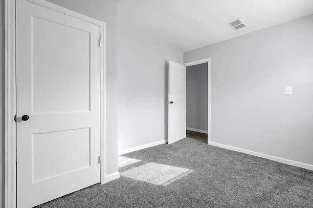 unfurnished bedroom featuring dark colored carpet