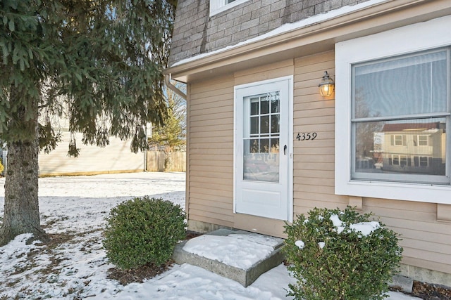 view of snow covered property entrance