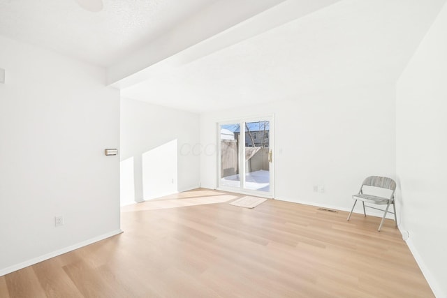 unfurnished room with light wood-type flooring