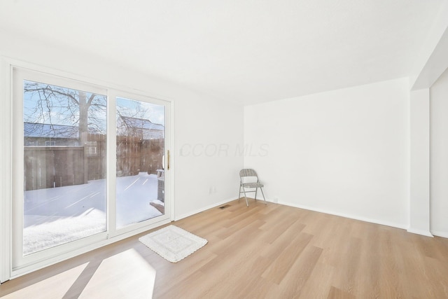 spare room featuring light hardwood / wood-style flooring