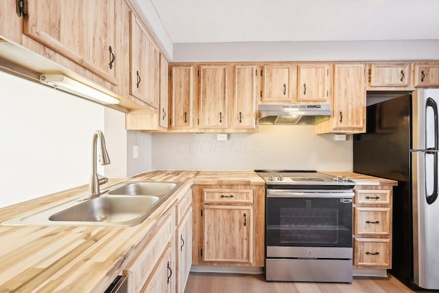 kitchen featuring butcher block counters, sink, stainless steel appliances, and light brown cabinetry