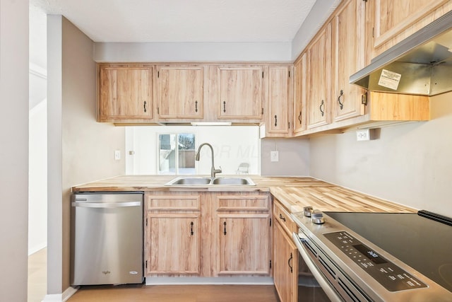 kitchen with light brown cabinetry, sink, stainless steel appliances, and butcher block counters