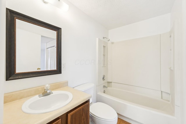 full bathroom featuring vanity, tub / shower combination, a textured ceiling, and toilet