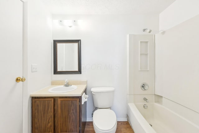 full bathroom with vanity, toilet, shower / bathing tub combination, and a textured ceiling