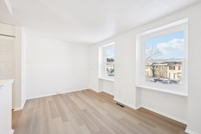 unfurnished room featuring light hardwood / wood-style floors