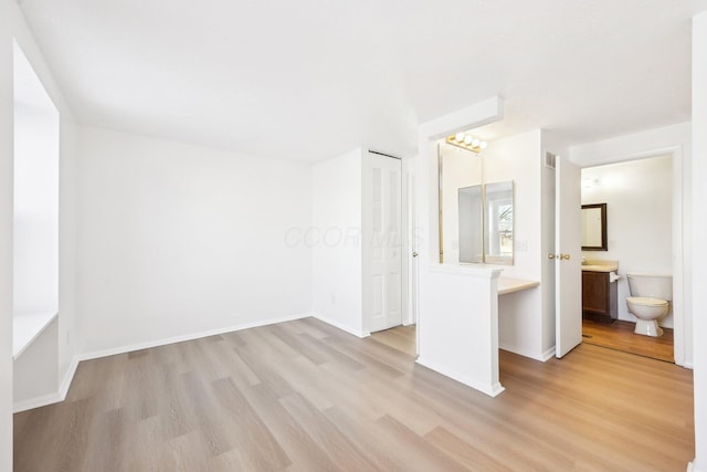 empty room with light hardwood / wood-style floors