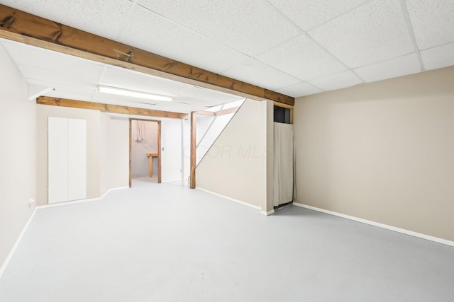 basement featuring a paneled ceiling