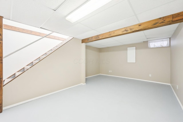 basement with a paneled ceiling