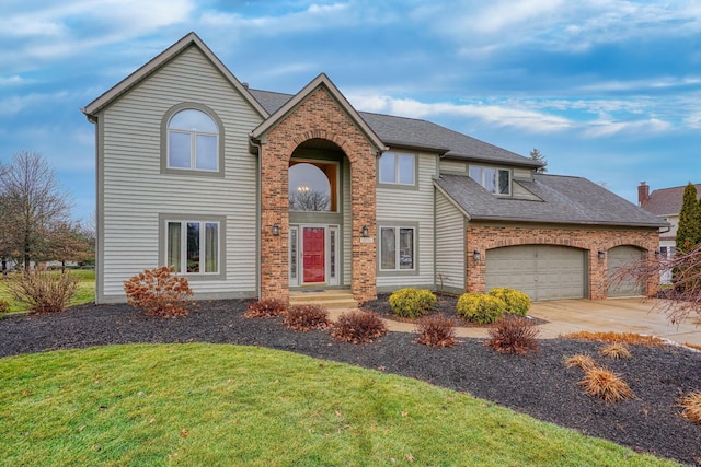 front facade with a garage and a front yard