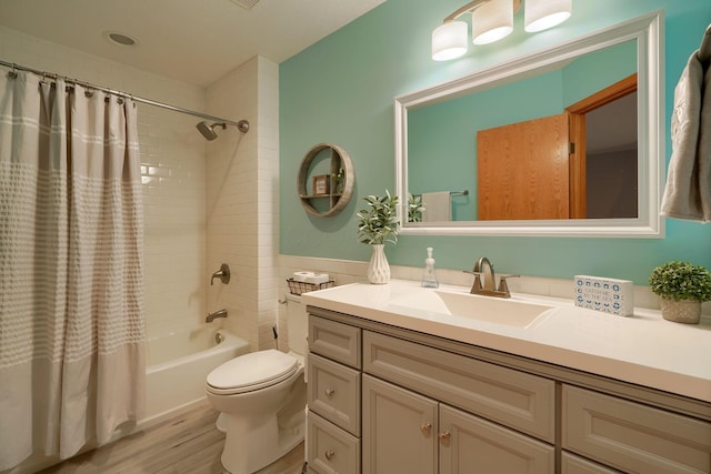 full bathroom featuring toilet, vanity, shower / bathtub combination with curtain, and hardwood / wood-style floors