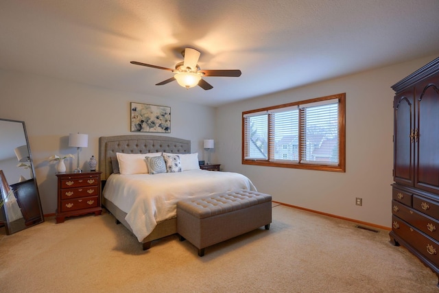 bedroom with ceiling fan and light colored carpet