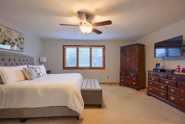 bedroom with ceiling fan and light colored carpet