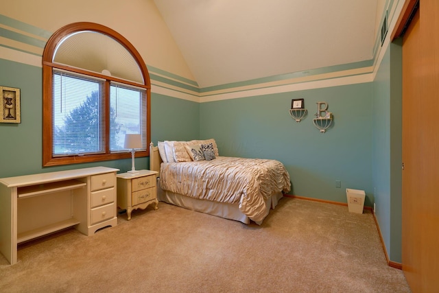 bedroom with vaulted ceiling and light carpet