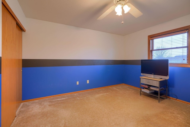 interior space with ceiling fan and carpet