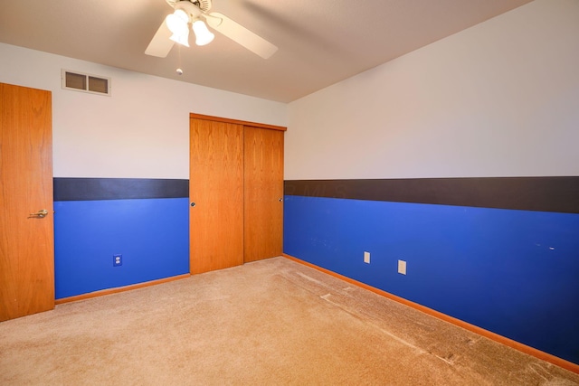 carpeted empty room with ceiling fan