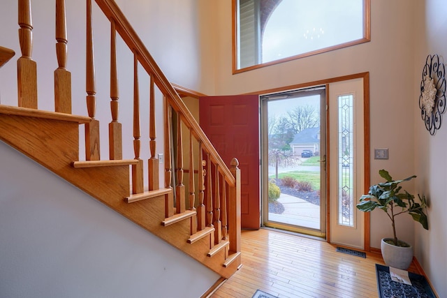 entrance foyer with a high ceiling and light wood-type flooring